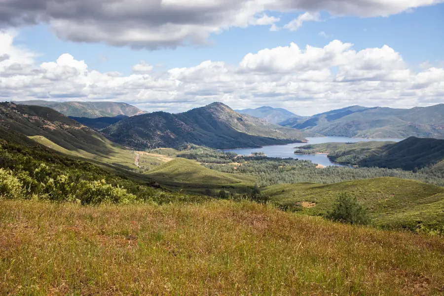 Lake McClure winding through green foothills
