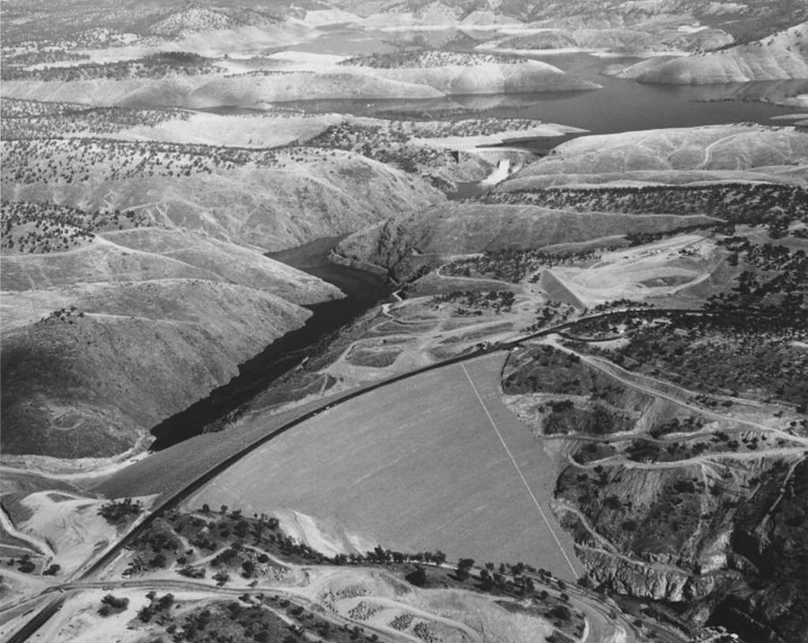 Aerial view of the new Don Pedro Dam's wide earthen face, with the old dam and the reservoir behind it