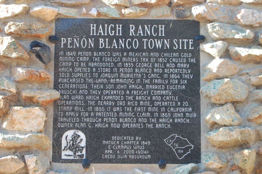 Dark metal plaque reading Haigh Ranch, Penon Blanco Town Site, set in a wall of fieldstones and white quartz, at the neighboring Haigh Ranch near Penon Blanco Road and Highway 49