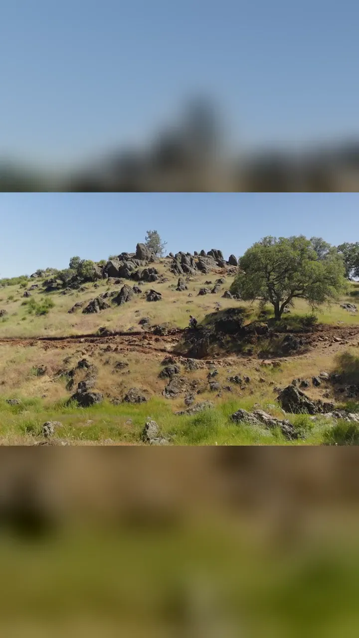 Jaret Brantley and his son riding a boulder meadow and red-dirt singletrack on our trails